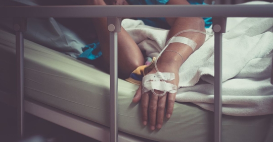 Truck accident victim lying in hospital bed